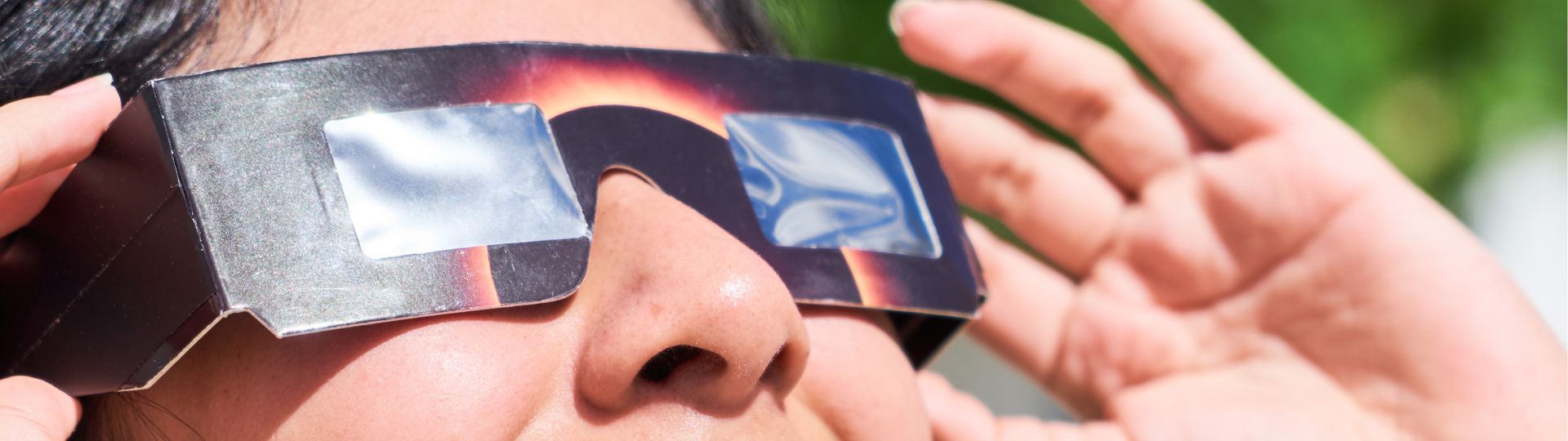 solar eclipse glasses on woman